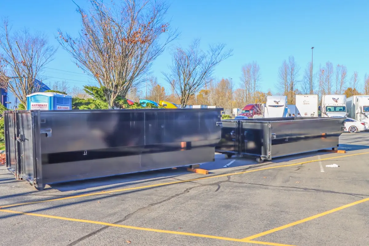 Professional dumpster rental service with roll-off container on residential driveway in Wildewood